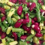 close up of green and yellow beans with kidney beans, parsley and onions