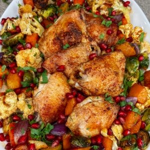 finished chicken and butternut squash with pomegranates on platter