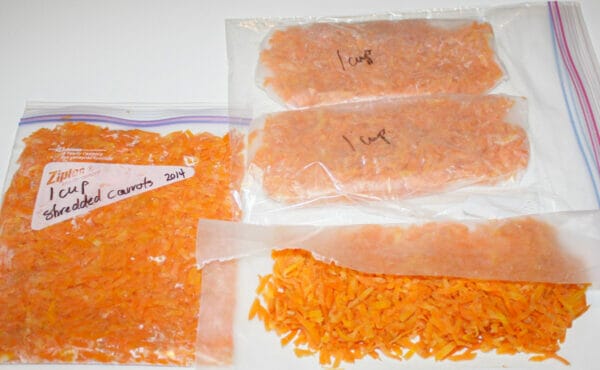 shredded carrots in 1 cup bag and several piles wrapped in wax paper

