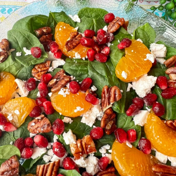 salad bowl with spinach, feta, pecans, mandarin oranges and pomegranates