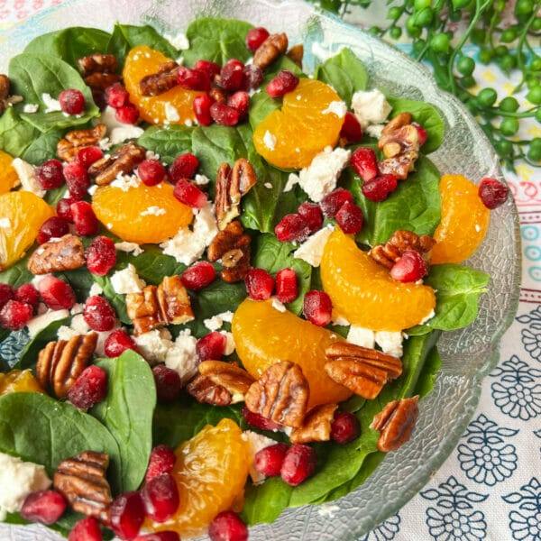 salad plate of spinach, mandarins, pecans, feta and pomegranates