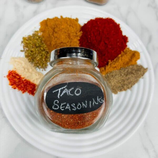 plate with 7 spices surrounding jar of taco seasoning