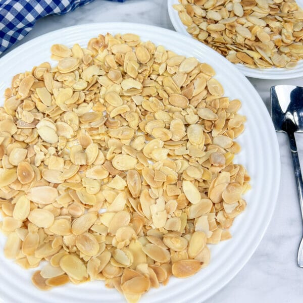 sliced toasted almonds on large dinner plate
