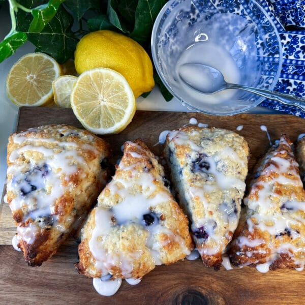 4 blueberry lemon scones with glaze on board