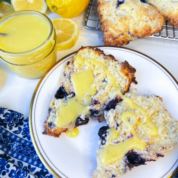 lemon blueberry scone opened on plate with lemon curd