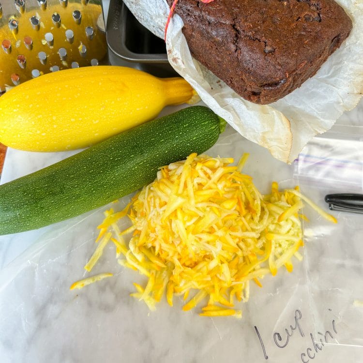 grated yellow zucchini on wax paper with 1 cup zucchini written in sharpie