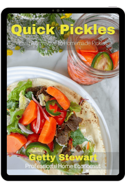 cover of quick pickles book with text and jar of pickled carrots