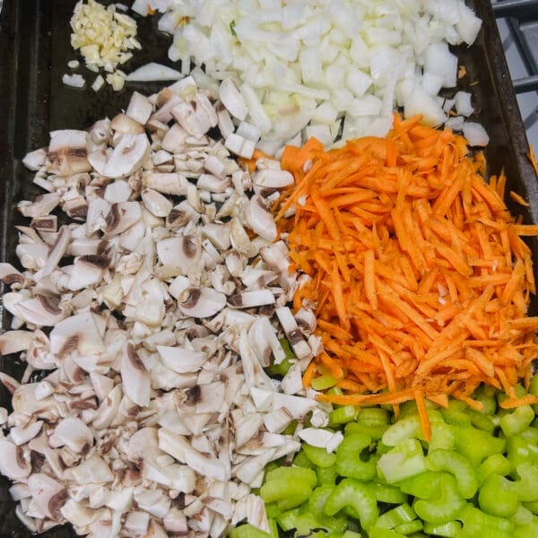 tray of chopped mushrooms, onions, garlic, carrots and celery