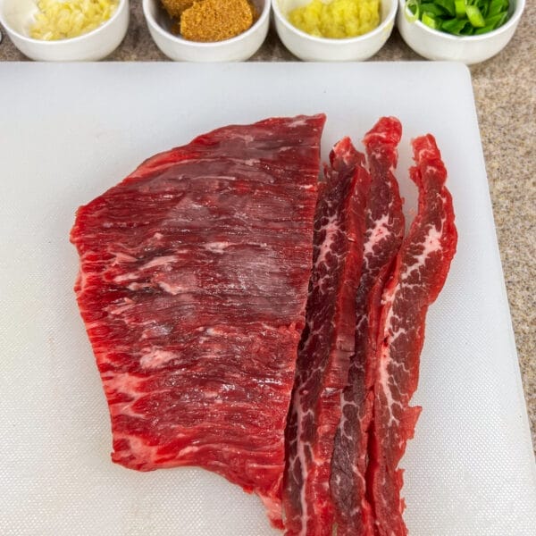 flank steak with grain showing and cut strips