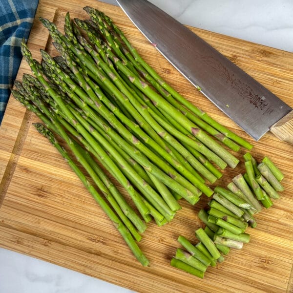 ends cut off bunch of asparagus on cutting board