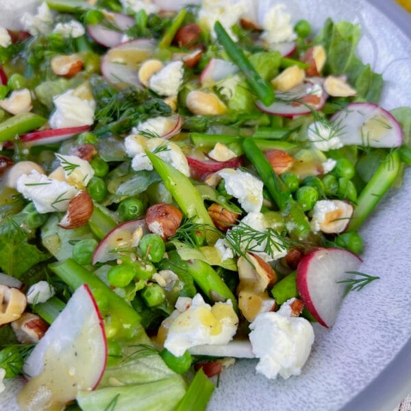 close up of asparagus salad on white plate