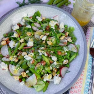 asparagus salad on plate dressing on side