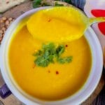 yellow split pea soup in bowl on spoon